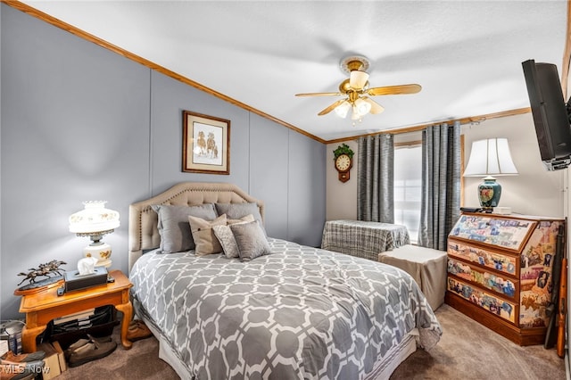 carpeted bedroom featuring a ceiling fan, lofted ceiling, and ornamental molding