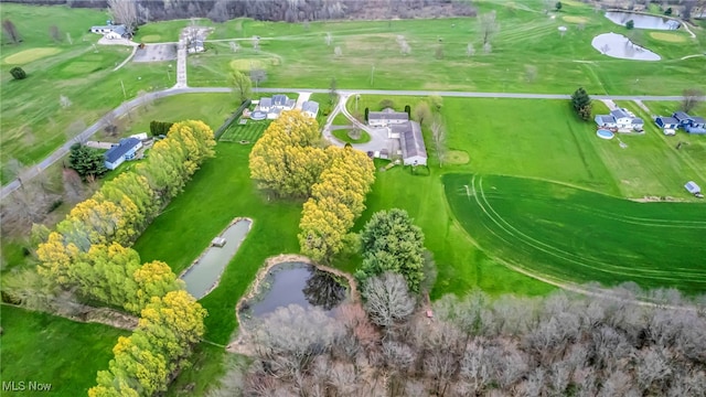 drone / aerial view featuring view of golf course and a water view