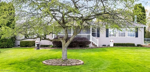 view of front of property with a front yard and stairway