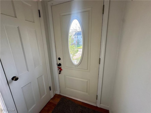 doorway with dark wood finished floors