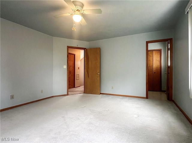 3799 Larchmont Ave NE, Bazetta, OH 44483 - empty room with light carpet, a ceiling fan, and baseboards