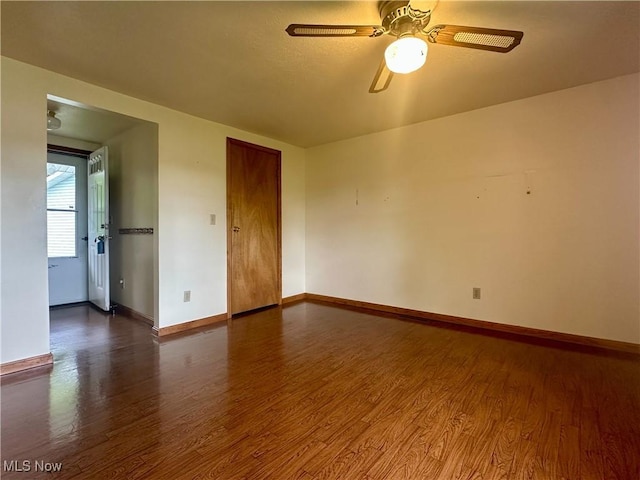 3799 Larchmont Ave NE, Bazetta, OH 44483 - spare room featuring dark wood-style flooring, baseboards, and a ceiling fan