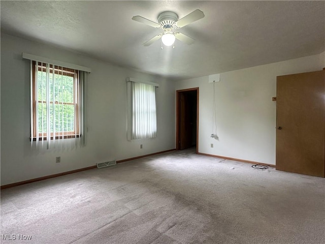3799 Larchmont Ave NE, Bazetta, OH 44483 - spare room featuring a ceiling fan, carpet flooring, and baseboards