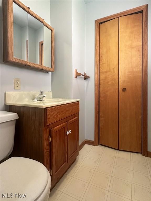 3799 Larchmont Ave NE, Bazetta, OH 44483 - bathroom with toilet, vanity, baseboards, and tile patterned floors