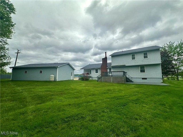3799 Larchmont Ave NE, Bazetta, OH 44483 - back of property featuring a deck and a lawn