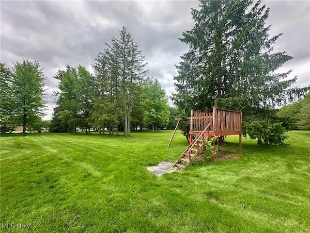 3799 Larchmont Ave NE, Bazetta, OH 44483 - view of green lawn with stairway and a deck