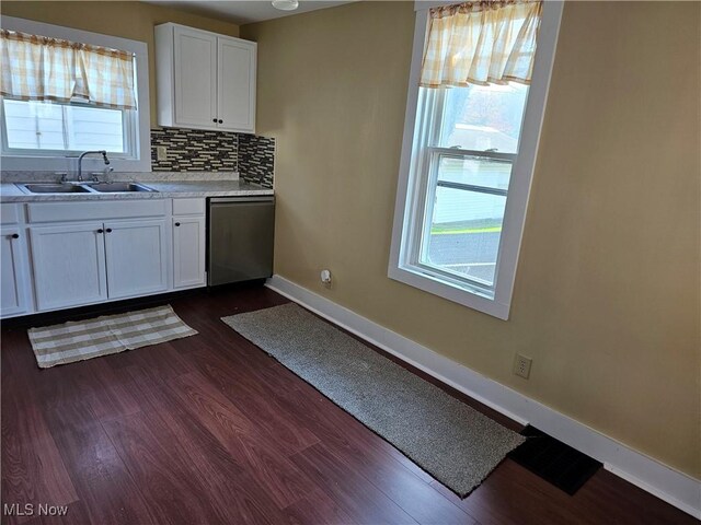 606 S 7th St, Cambridge, OH 43725 - kitchen featuring a sink, dishwasher, baseboards, and dark wood-type flooring