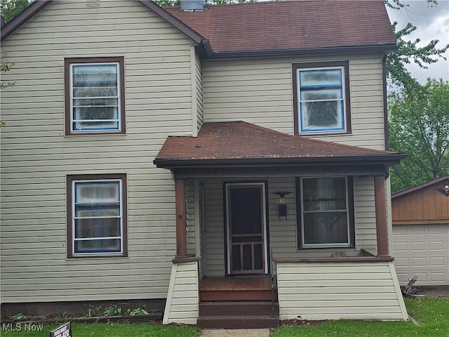 606 S 7th St, Cambridge, OH 43725 - view of front of house featuring roof with shingles, a chimney, and an outdoor structure