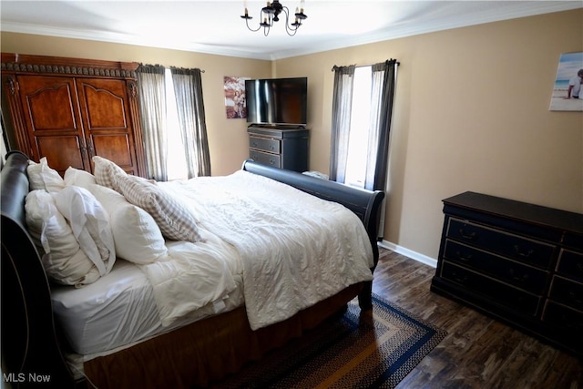 bedroom featuring baseboards, ornamental molding, dark wood-style floors, and a notable chandelier