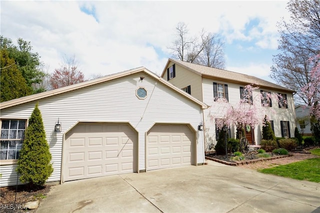 colonial-style house featuring a garage and concrete driveway