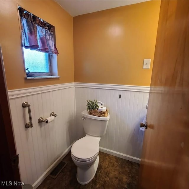 243 Hagan St, Adena, OH 43901 - bathroom with baseboards, wainscoting, toilet, and visible vents