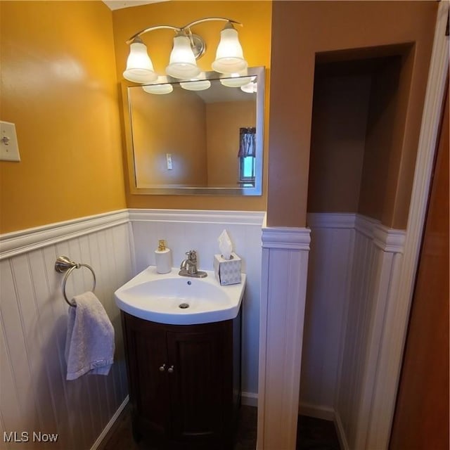 243 Hagan St, Adena, OH 43901 - bathroom featuring a wainscoted wall, vanity, and a decorative wall