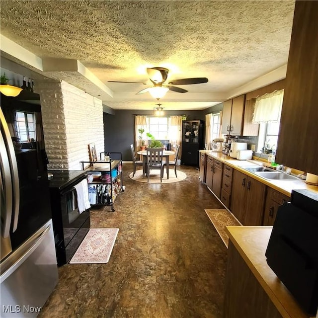243 Hagan St, Adena, OH 43901 - kitchen featuring a ceiling fan, a textured ceiling, a sink, light countertops, and freestanding refrigerator