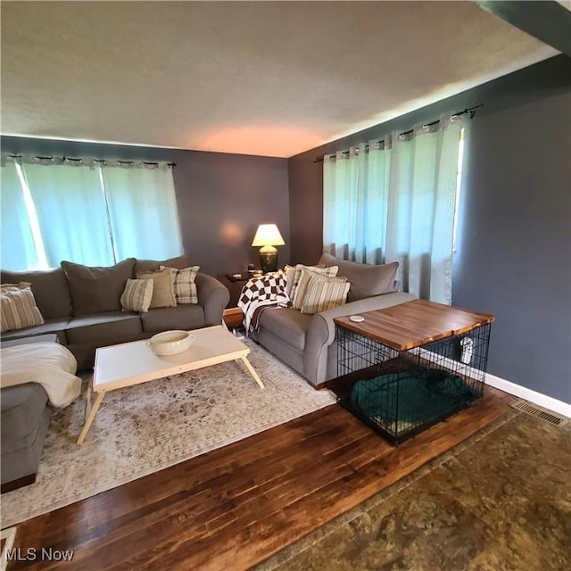 243 Hagan St, Adena, OH 43901 - living area with baseboards, wood finished floors, and visible vents