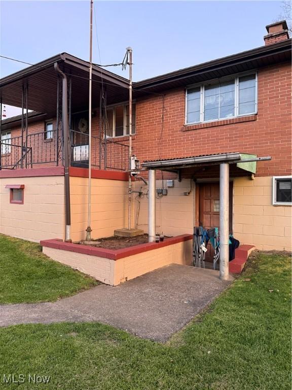 243 Hagan St, Adena, OH 43901 - back of house featuring brick siding and a chimney