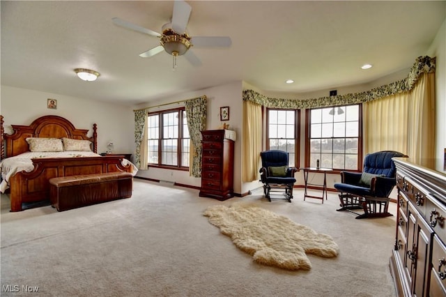 carpeted bedroom featuring baseboards and recessed lighting
