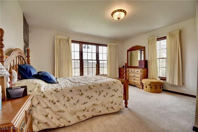 carpeted bedroom with baseboards