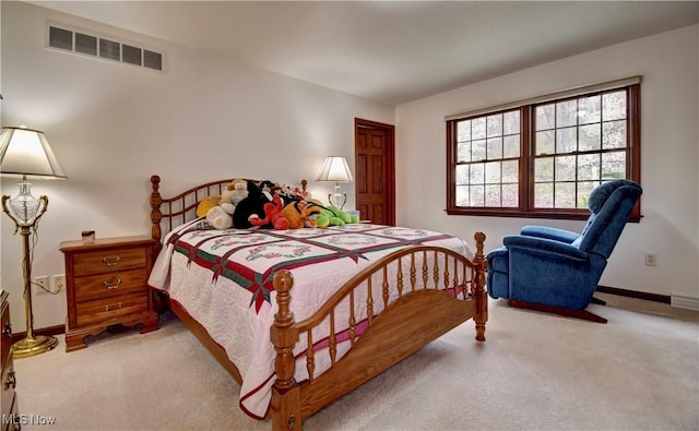 bedroom featuring baseboards, visible vents, and carpet