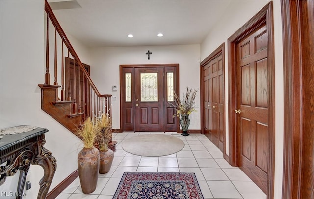 entrance foyer featuring light tile patterned floors, baseboards, stairs, and recessed lighting