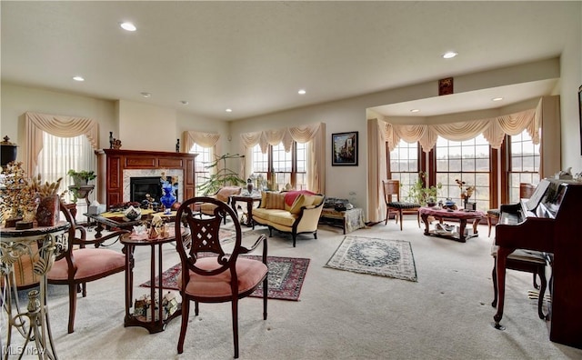 living room featuring a fireplace, light carpet, and recessed lighting