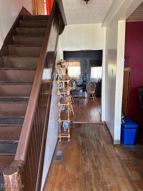 214 Jarvis St, Bowerston, OH 44695 - staircase featuring hardwood / wood-style flooring and visible vents
