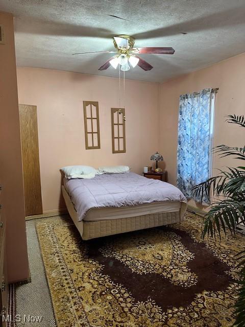 214 Jarvis St, Bowerston, OH 44695 - bedroom featuring ceiling fan, baseboards, a textured ceiling, and visible vents