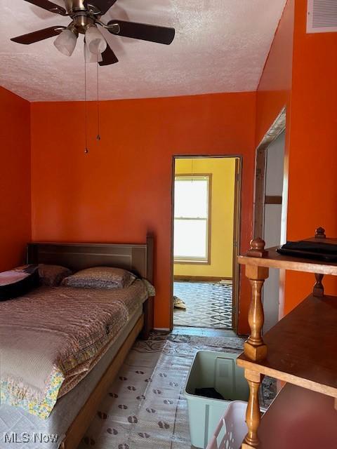 214 Jarvis St, Bowerston, OH 44695 - bedroom with visible vents, a textured ceiling, and ceiling fan