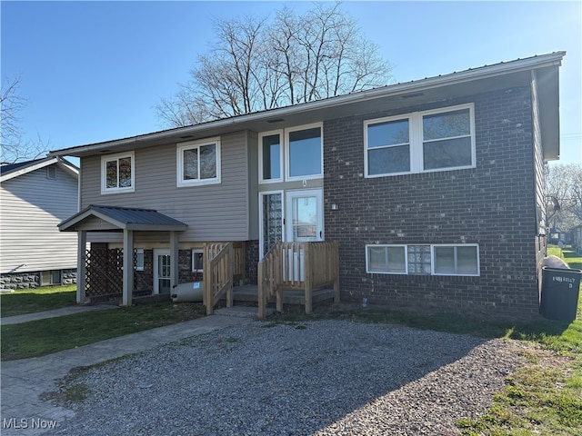 bi-level home featuring brick siding