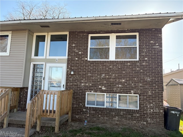 doorway to property with brick siding