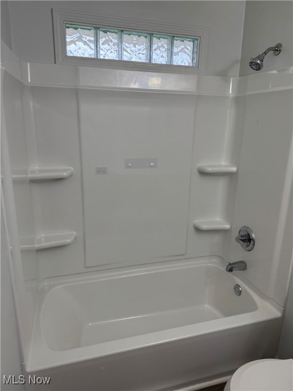 bathroom featuring toilet and shower / washtub combination