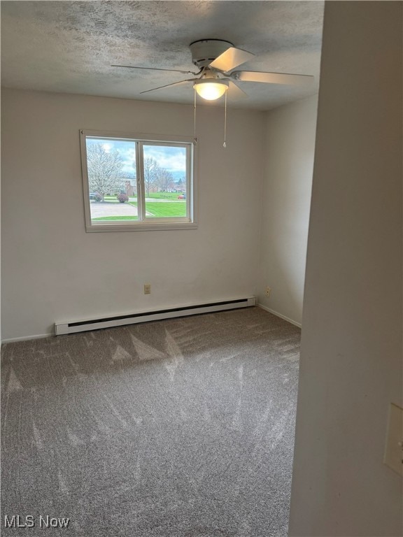 unfurnished room with baseboard heating, a ceiling fan, a textured ceiling, carpet, and baseboards