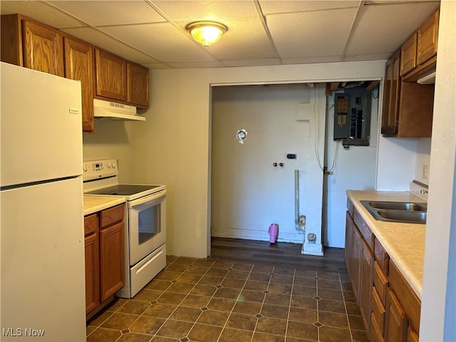 kitchen with under cabinet range hood, a sink, white appliances, electric panel, and brown cabinetry