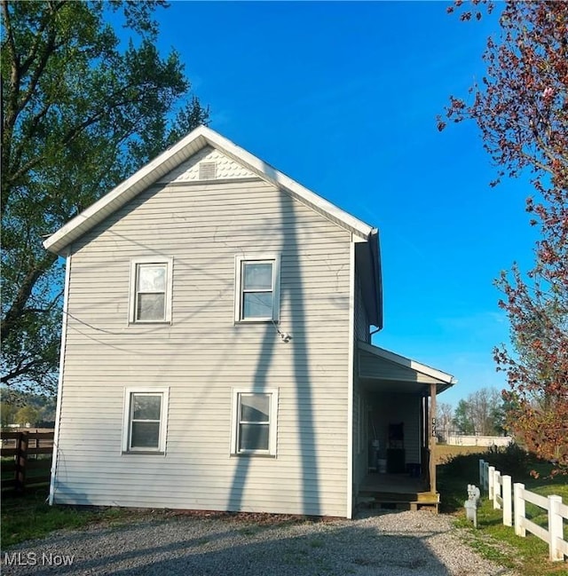 view of home's exterior with fence