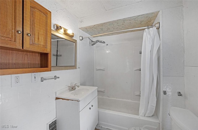 bathroom with shower / bath combo, toilet, vanity, and visible vents