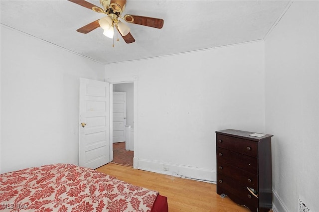 bedroom with light wood finished floors and a ceiling fan