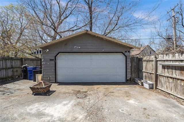 detached garage featuring fence