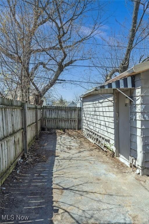 wooden deck with a fenced backyard and a patio