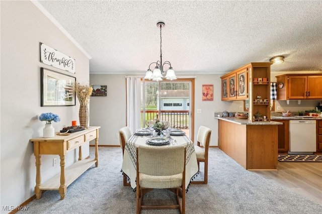 dining room with baseboards, ornamental molding, an inviting chandelier, and a textured ceiling