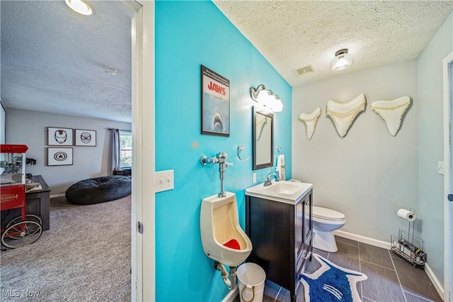 3411 Wood Rd, Madison, OH 44057 - bathroom featuring a textured ceiling, toilet, a sink, and baseboards