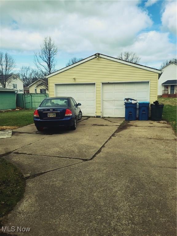 detached garage featuring fence