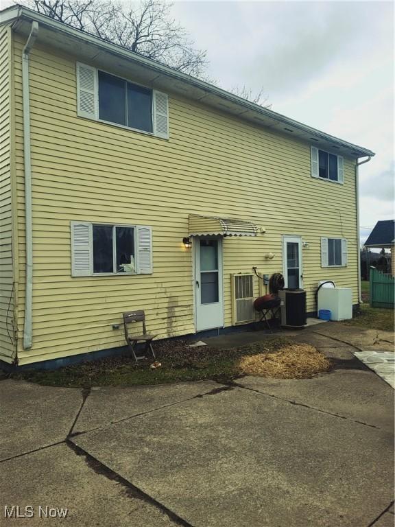back of house with cooling unit and a patio