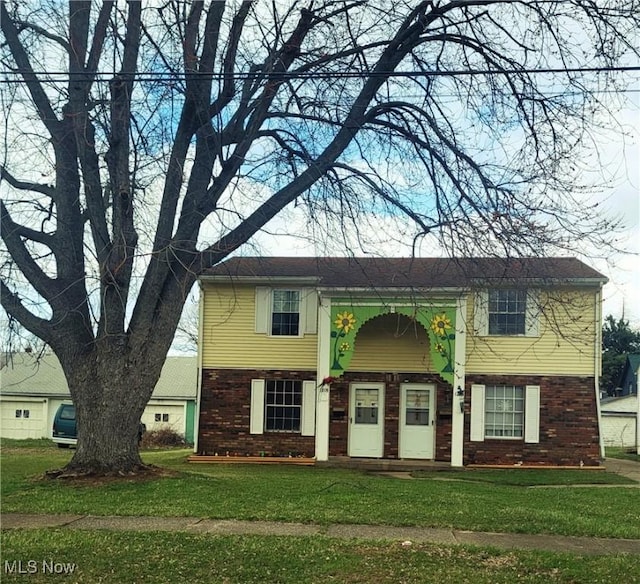 view of front of property with brick siding and a front lawn
