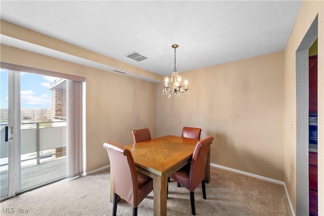 dining room featuring baseboards, light colored carpet, and an inviting chandelier