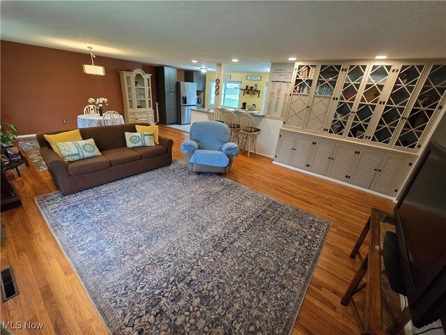 living area with wood finished floors and recessed lighting