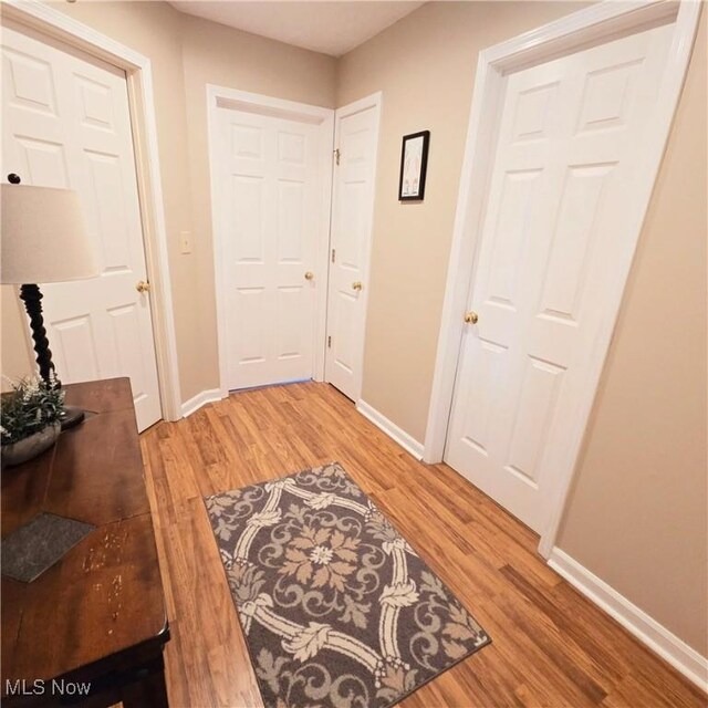 doorway to outside featuring light wood-style floors and baseboards