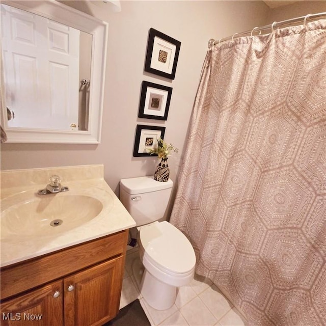 bathroom with tile patterned floors, vanity, and toilet