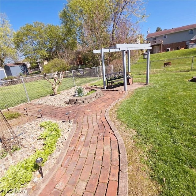 view of yard featuring a pergola and fence