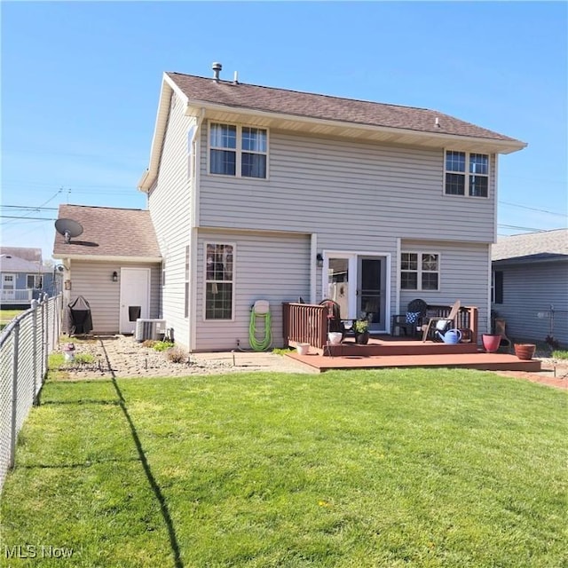 rear view of house featuring a fenced backyard, a yard, and a deck