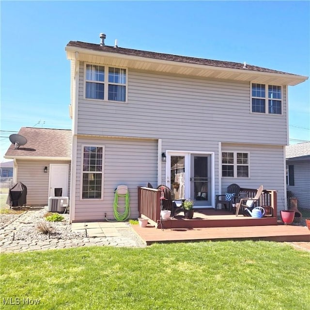 back of house with a lawn and a deck