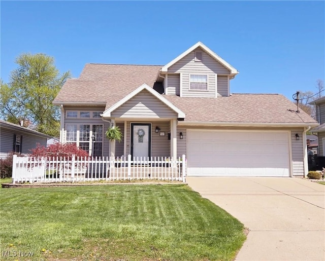 traditional home featuring a front lawn, concrete driveway, fence, an attached garage, and a shingled roof
